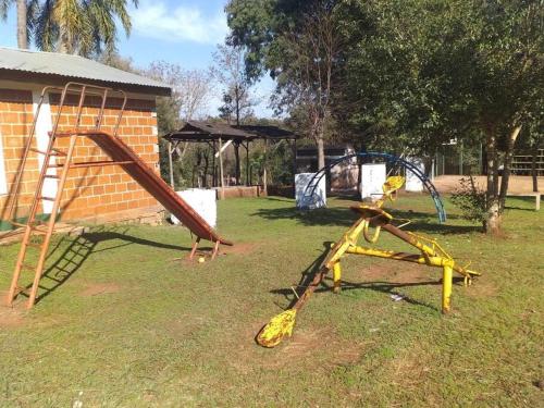 a group of playground equipment in a yard at Casa del monte, en cercanía de arroyo y balneario in Puerto Rico