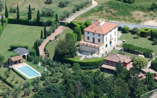an aerial view of a large house with a pool at Podere Sant'Antonio in Fauglia