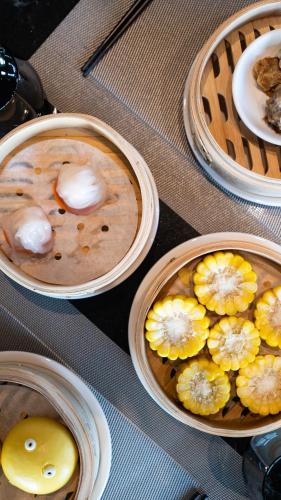 a table with three bowls of food on a table at Radisson RED Hotel Zhuhai Gongbei Port in Zhuhai