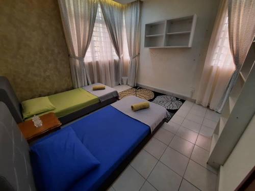 a room with two beds and a window at HillTree Homestay Putrajaya in Putrajaya