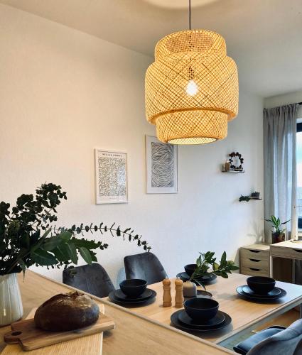 a dining room with a table and a light fixture at Schickes, Stilvolles und Helles Apartment in Münster in Münster