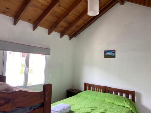 A bed or beds in a room at Kaiken - Hostel & Departamentos