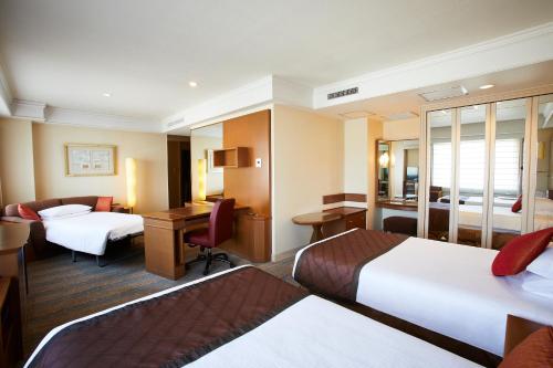 Ένα ή περισσότερα κρεβάτια σε δωμάτιο στο Royal Park Hotel