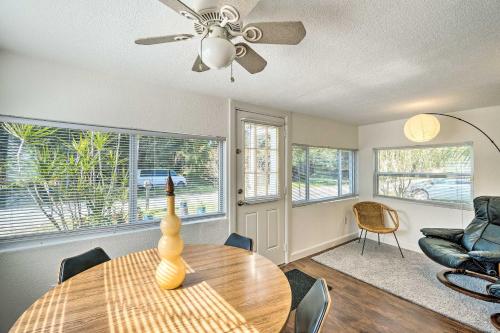 a living room with a table and a ceiling fan at Tropical Port Charlotte Cottage - Walk to Bay! in Port Charlotte