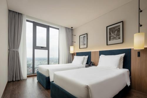 Ένα ή περισσότερα κρεβάτια σε δωμάτιο στο Mandala Hotel & Suites Bac Giang