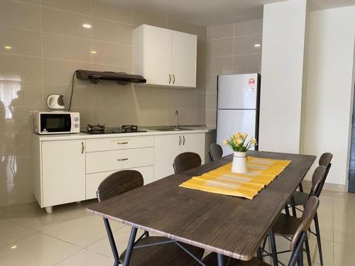 a kitchen with a table with chairs and a refrigerator at Sky Bungalow NIlai by James NEARBY KLIA, KLIA 2, CYBERJAYA, PUTRAJAYA in Nilai