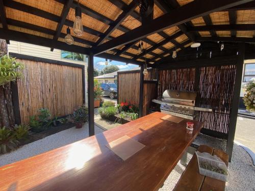 a wooden table in the middle of a patio at Opononi Lighthouse Motel in Opononi