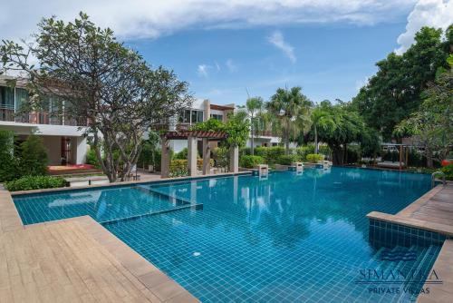 a large swimming pool in a resort at Simantra Private Villas in Cha Am