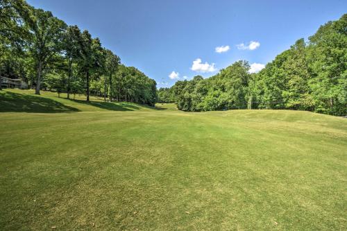 a large green field with trees in the background at Comfy Jasper Getaway with Community Amenities! in Jasper