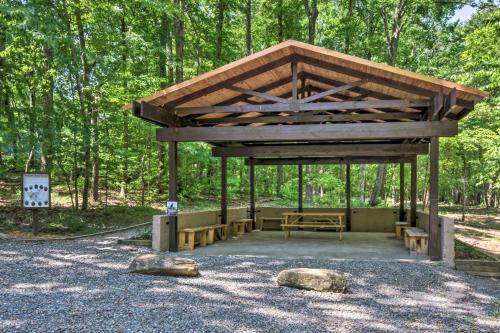 a wooden pavilion with a picnic table and benches at Comfy Jasper Getaway with Community Amenities! in Jasper