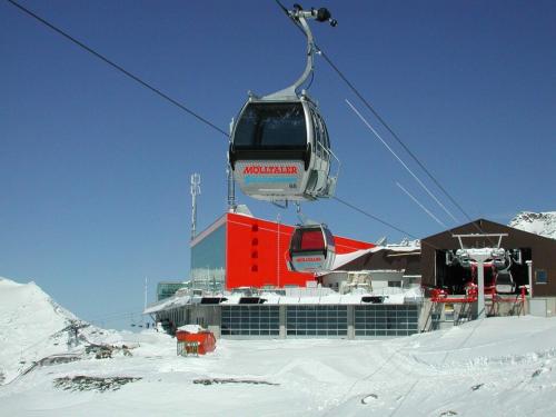 a ski lift with a building in the snow at Holiday home in Obervellach near ski area in Obervellach