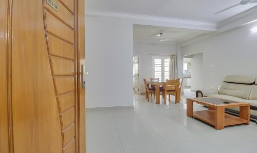 a living room with a couch and a table at Treebo Rithikha Inn Elite Chennai Trade Centre in Chennai