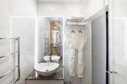 ビシュケクにあるOrient Hotel Bishkekの洗面台と鏡のある白いバスルーム
