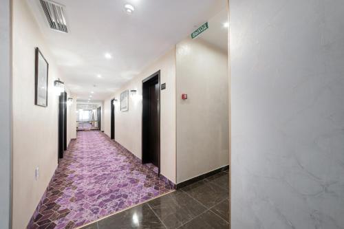 a hallway with a purple floor in a building at Orient Hotel Bishkek in Bishkek