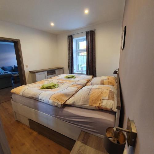 a large bed in a room with a large window at Ferienwohnung-Am-Markt in Harzgerode