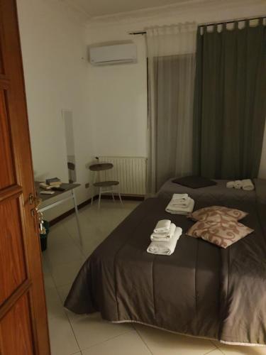 a hotel room with a bed with towels on it at Alba central City in Palermo