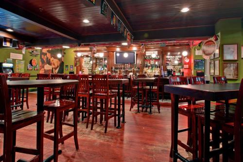 a bar with tables and chairs in a restaurant at Holiday Inn St Johns by IHG in St. John's