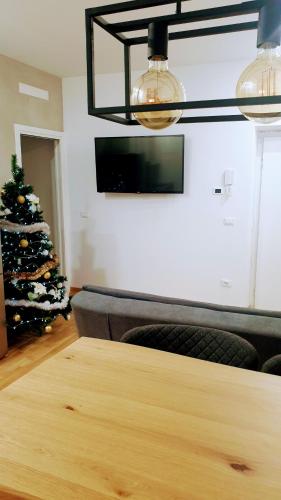 a dining room with a table and a christmas tree at Casa Caterina in Mantova