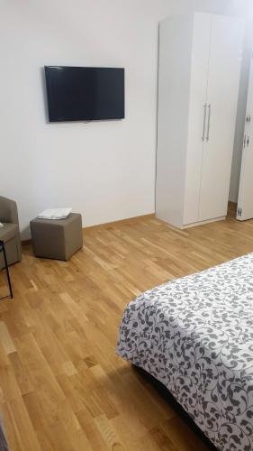 a bedroom with a bed and a flat screen tv at Casa Caterina in Mantova