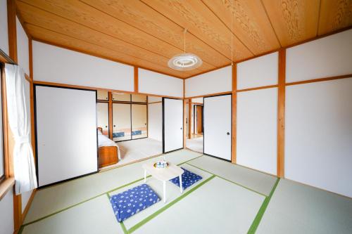 an empty room with windows and a table at Second House Nikko in Nikko