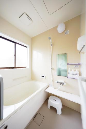 a bathroom with a tub and a sink and a toilet at Second House Nikko in Nikko