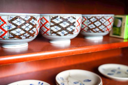 a group of bowls sitting on a shelf at Second House Nikko in Nikko