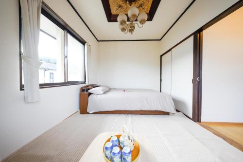 a bedroom with a bed with a bowl on a table at Second House Nikko in Nikko