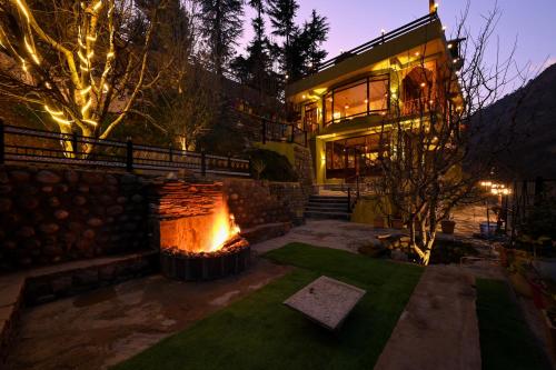 a house with a fire place in front of it at Zostel Dobhi, Manali in Nagar