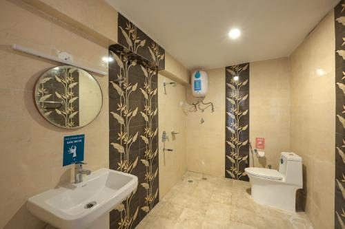 a bathroom with a sink and a toilet and a mirror at Zostel Dobhi, Manali in Nagar