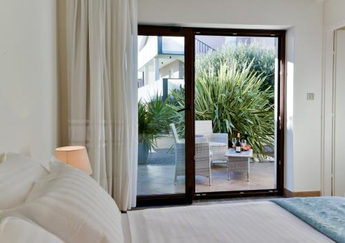 a bedroom with a bed and a sliding glass door at Apartments Villa Rosi in Umag