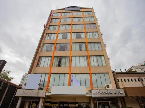 a tall building with orange poles on it at Super OYO 838 Manila Crown Palace Hotel in Manila