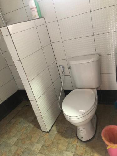 a bathroom with a white toilet in a stall at บ้านทองอาทรเขาค้อ in Khao Kho