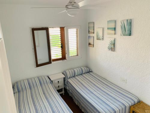 a room with two beds and a window at CASA DUPLEX BUNGALOW Dénia in Denia