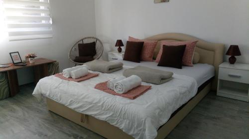 a bedroom with a large bed with towels on it at Happy Star in Niš