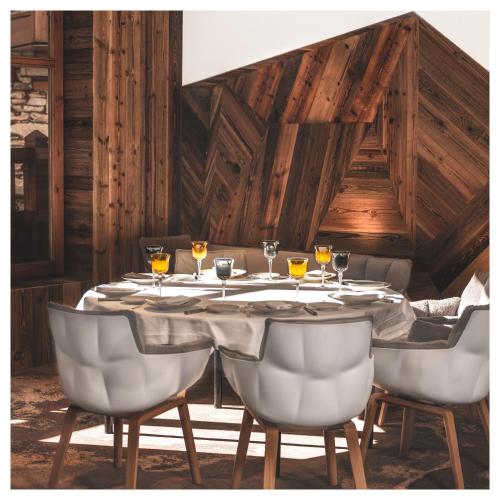 a table with wine glasses on top of it at Hôtel Les Barmes De l'Ours in Val-d'Isère