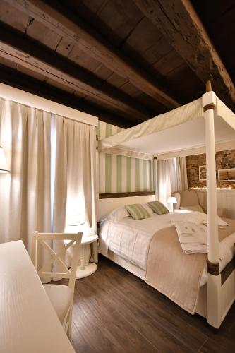 a bedroom with two beds and a canopy bed at Al Palazzetto in Udine