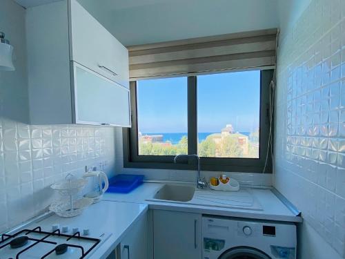 a small kitchen with a sink and a window at Prestige Studios in Kyrenia