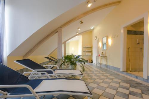 a group of chairs in a room with a staircase at Hotel Sailer in Innsbruck