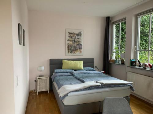 a bedroom with a bed with a yellow pillow on it at Gleich neben Dom und Schloss in Limburg an der Lahn