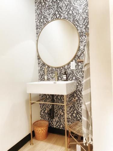 a bathroom with a sink and a mirror on a wall at The Shack Inn in Homer