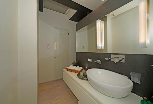 a bathroom with a large white tub and a mirror at Casa Veronica in Manerba del Garda