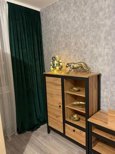 a wooden cabinet with a toy tiger on top of it at Apartament Nova przy S3 in Nowa Sól