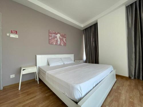 a bedroom with a large white bed and a table at Sky Bungalow NIlai by James NEARBY KLIA, KLIA 2, CYBERJAYA, PUTRAJAYA in Nilai