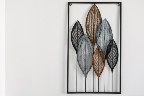 a group of feathers on a wall at Materdays 24 in Naples