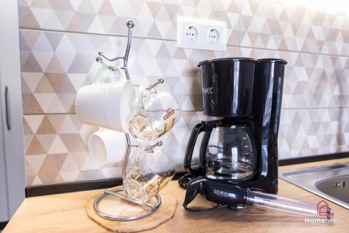 a kitchen counter with a coffee maker on a counter top at Eleutheria's Project By Homebrain in Alexandroupoli