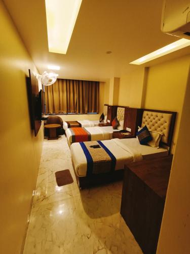 a hotel room with two beds and a television at Mayda Inn- A Boutique Hotel in New Delhi