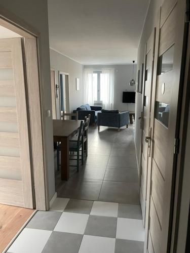 a living room with a table and a dining room at Apartamenty Komorniki in Komorniki