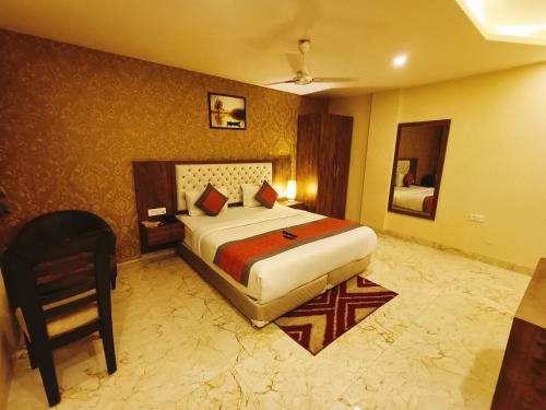 a hotel room with a bed and a chair at Mayda Inn- A Boutique Hotel in New Delhi