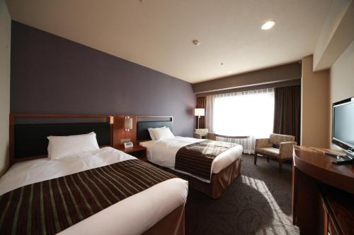 Un ou plusieurs lits dans un hébergement de l'établissement Hotel Metropolitan Sendai