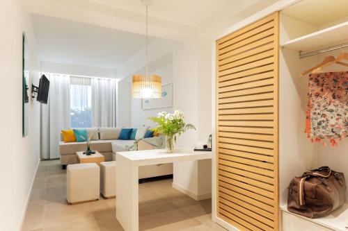 a living room with a white table and a couch at Albatros Beach Hotel in Letojanni